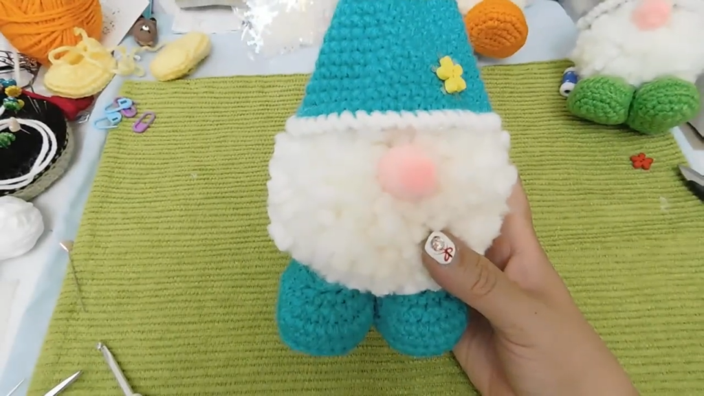 Gluing the crochet gnome pieces together