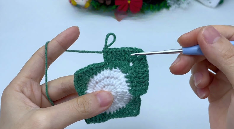 Extra green rows on top of the crochet Christmas candy pouch.