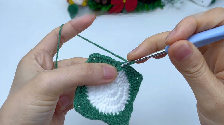 Double crochet rounds added to the green border.