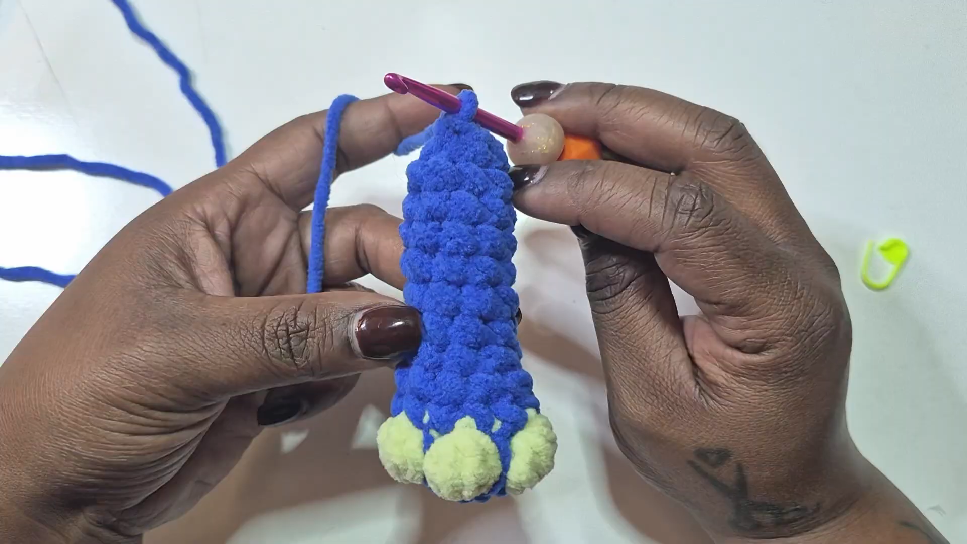 Blue crochet leg piece with pale green toes