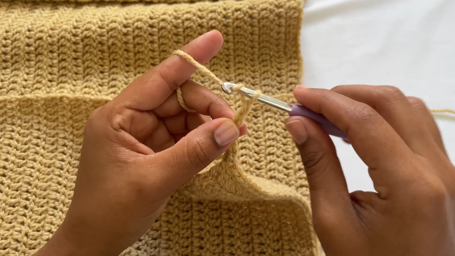 Chaining tan yarn to start the ribbed band.