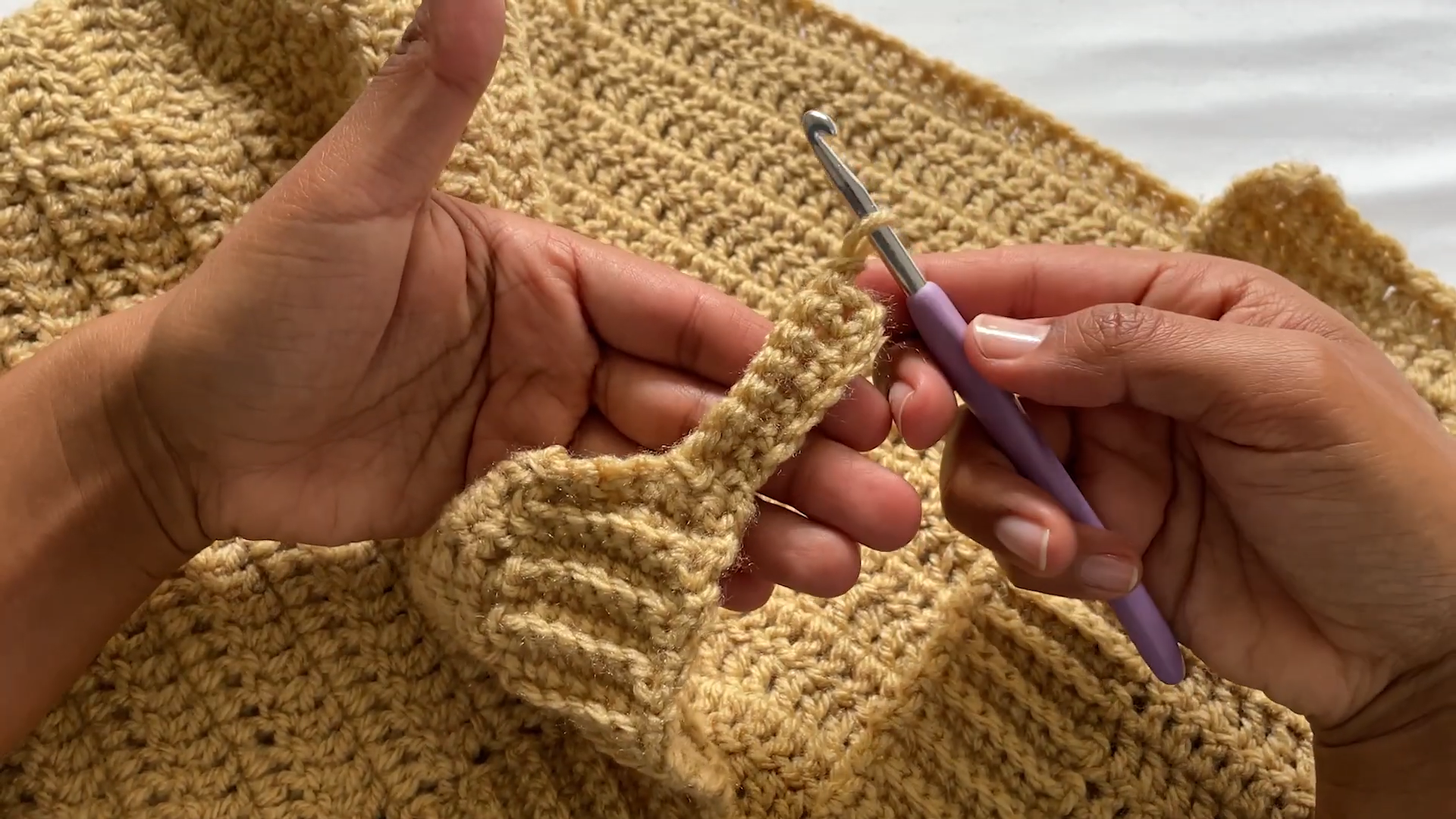 Crocheting a narrow ribbed strip from the edge.