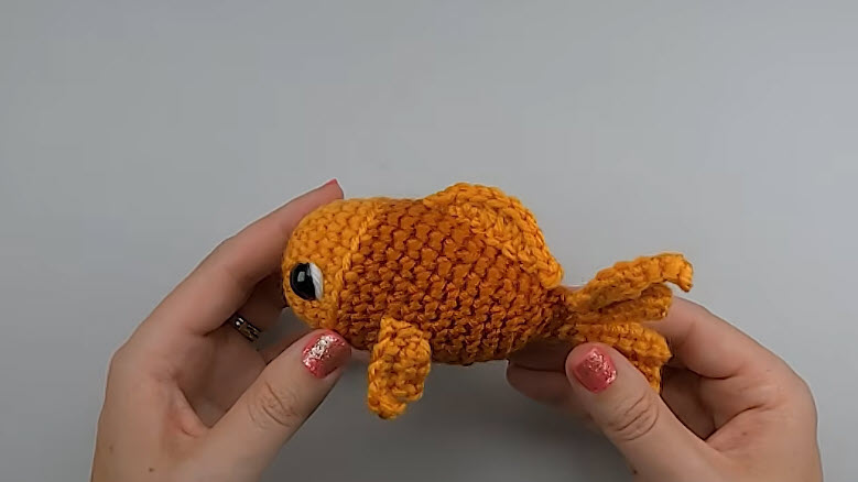 Finished crochet fish amigurumi with flowing fins.