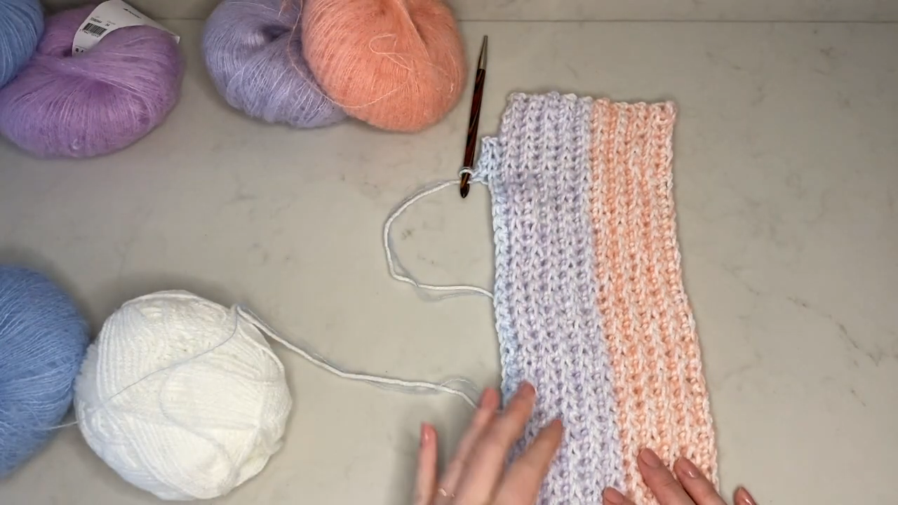 Lilac and peach stripes forming the crochet ribbed sweater panel.