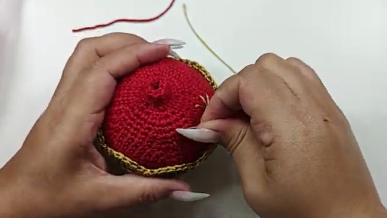 Red crown of the ornament with a gold border