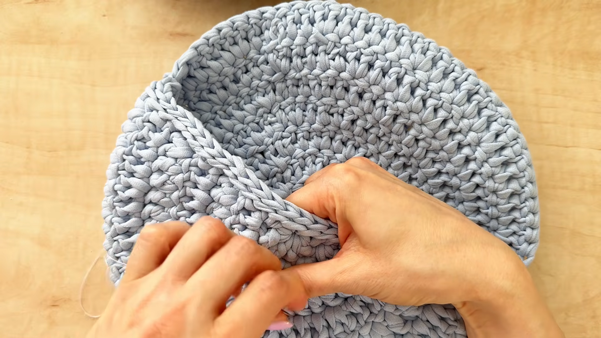 Shaping the flap over the round front of the crochet fanny pack crossbody bag