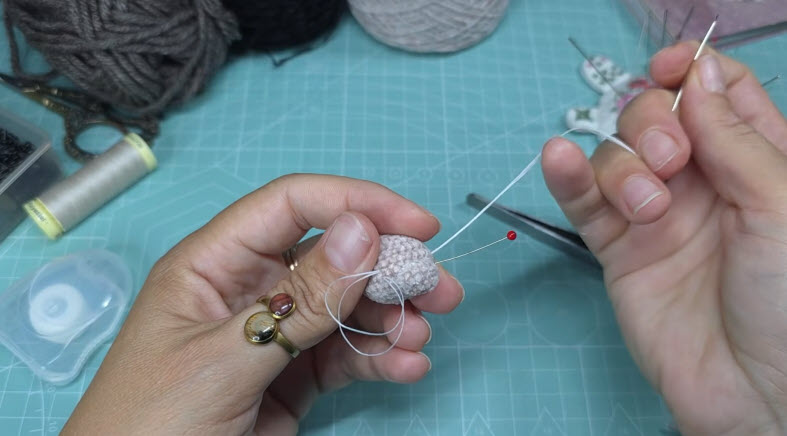 Shaping the mini pony face with needle and thread
