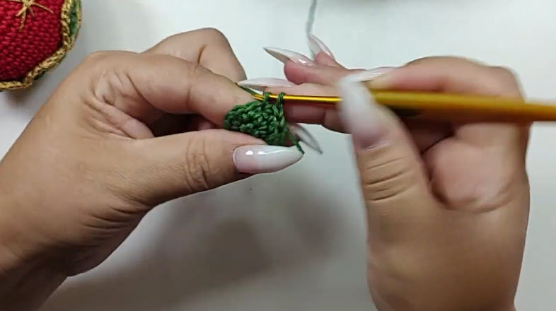 Green base of the ornament started with a magic ring