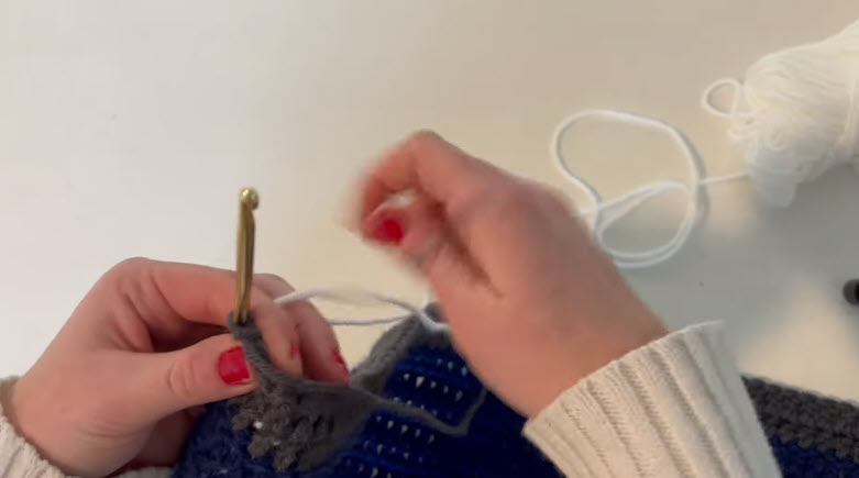 Switching to white yarn above the grey stripe.