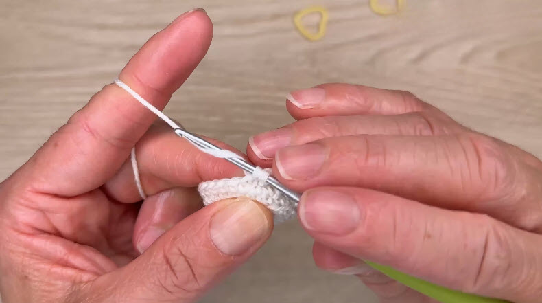White yarn round being crocheted on starting ring