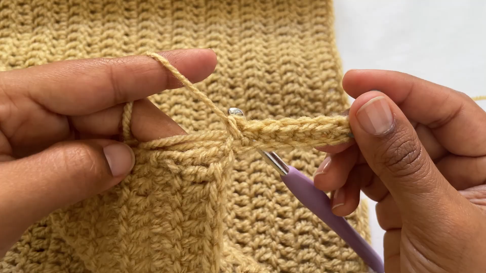 Working band stitches along the cardigan front edge.