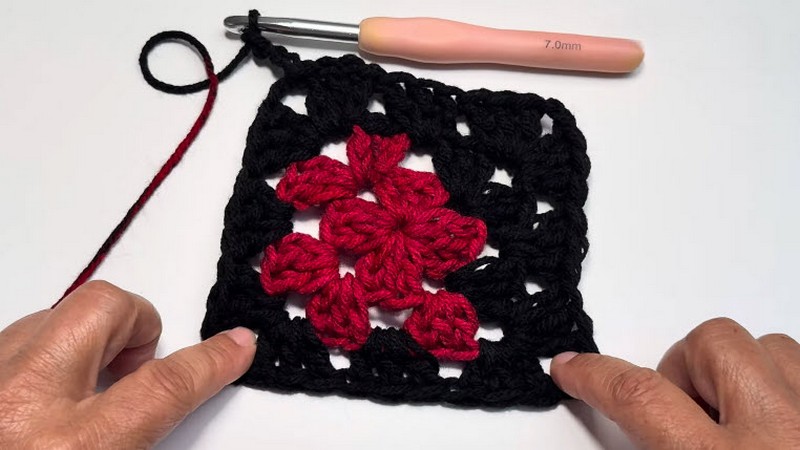 Finished red and black granny square with a 7.0mm hook.