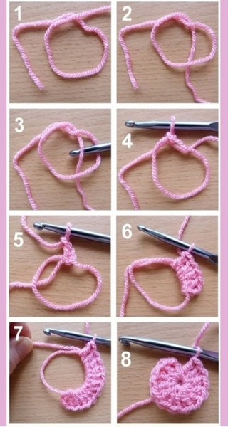 Pink yarn circle with a crochet hook beginning a magic ring